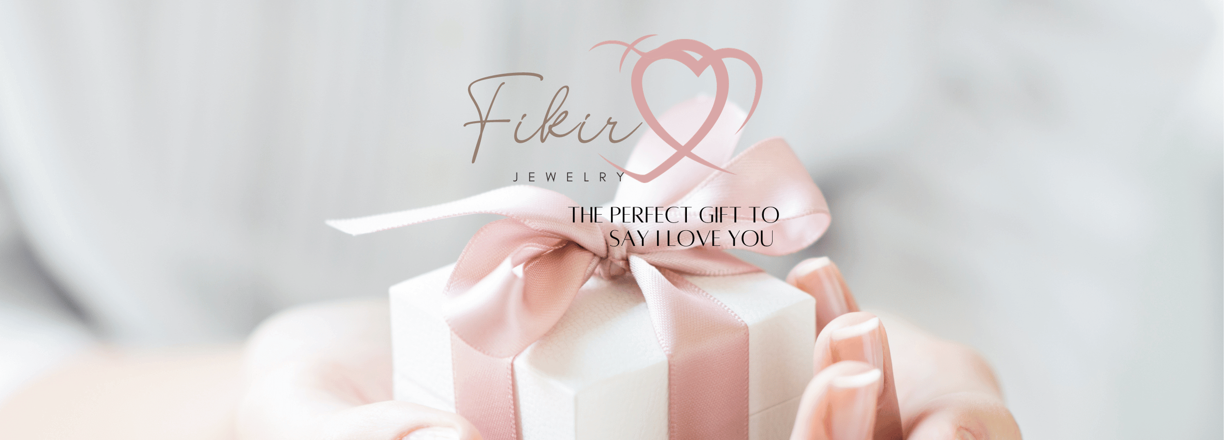 Fikir Jewelry Banner with logo of two pink interlinked hearts and a woman holding a white Jewelry box with a pint bow.
