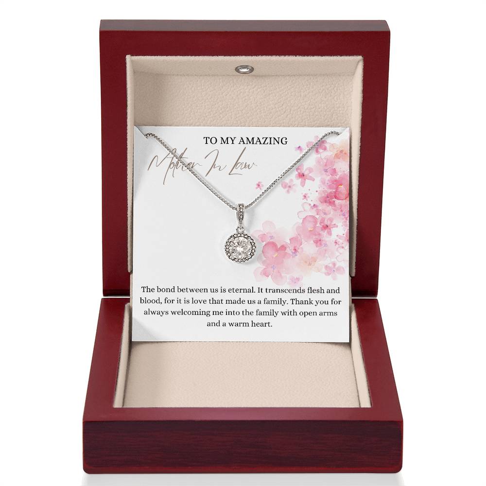 A necklace gift with a big cubic zirconia crystal pendant and a white gold finish, with a message card to my amazing mother-in-law, in a mahogany Jewelry box.