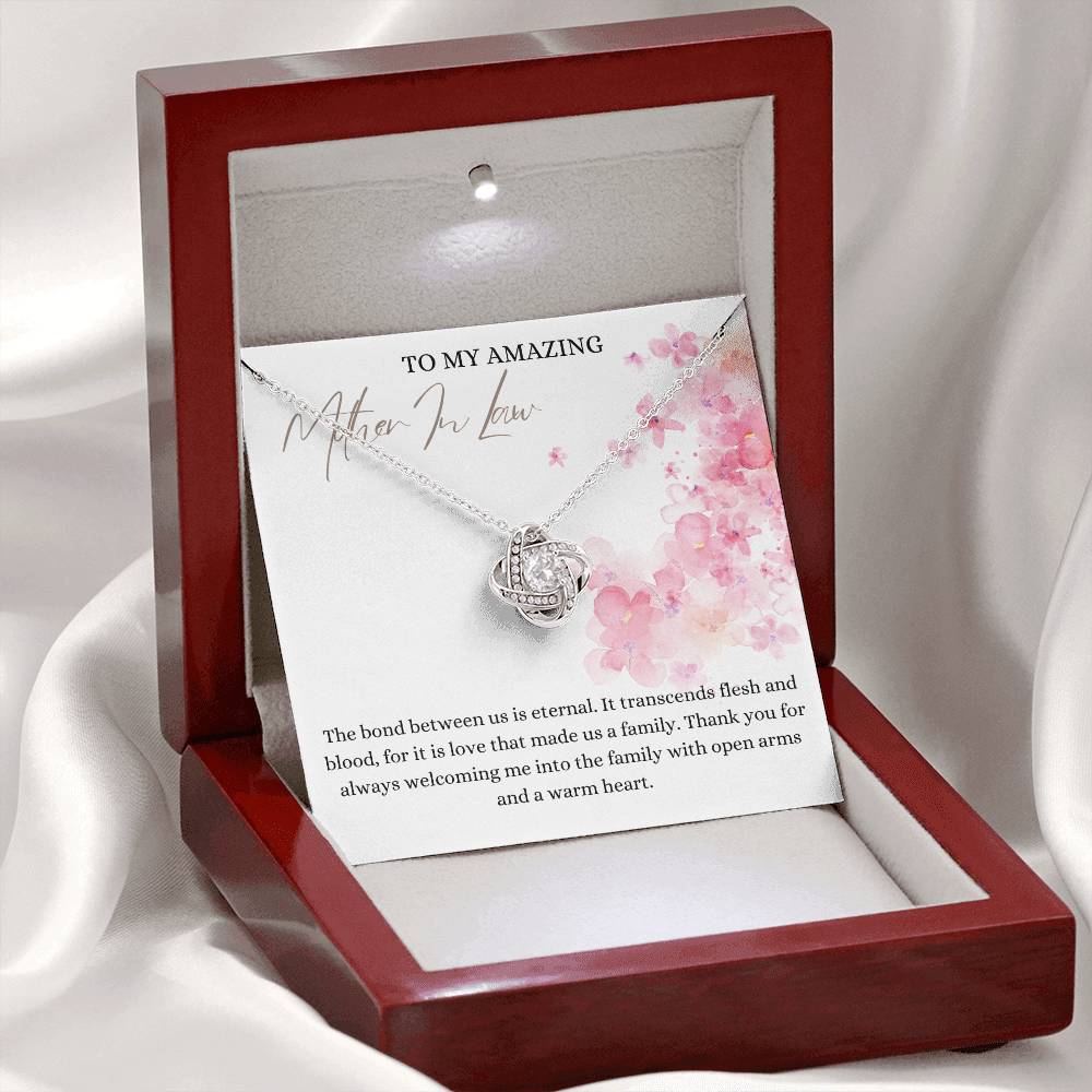 A white gold finish necklace gift, with a knot pendant embellished with premium cubic zirconia crystals, and a message card to my amazing mother-in-law, in a mahogany Jewelry box.