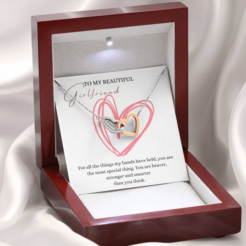 A mahogany Jewelry box, with a necklace with two connected hearts embellished with cubic zirconia crystals and white gold finish, with a message beautiful girlfriend.