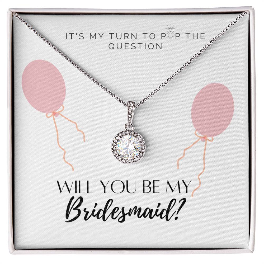 A necklace gift with a big cubic zirconia crystal pendant and a white gold finish, with a message card to bridesmaids, in a Jewelry box.