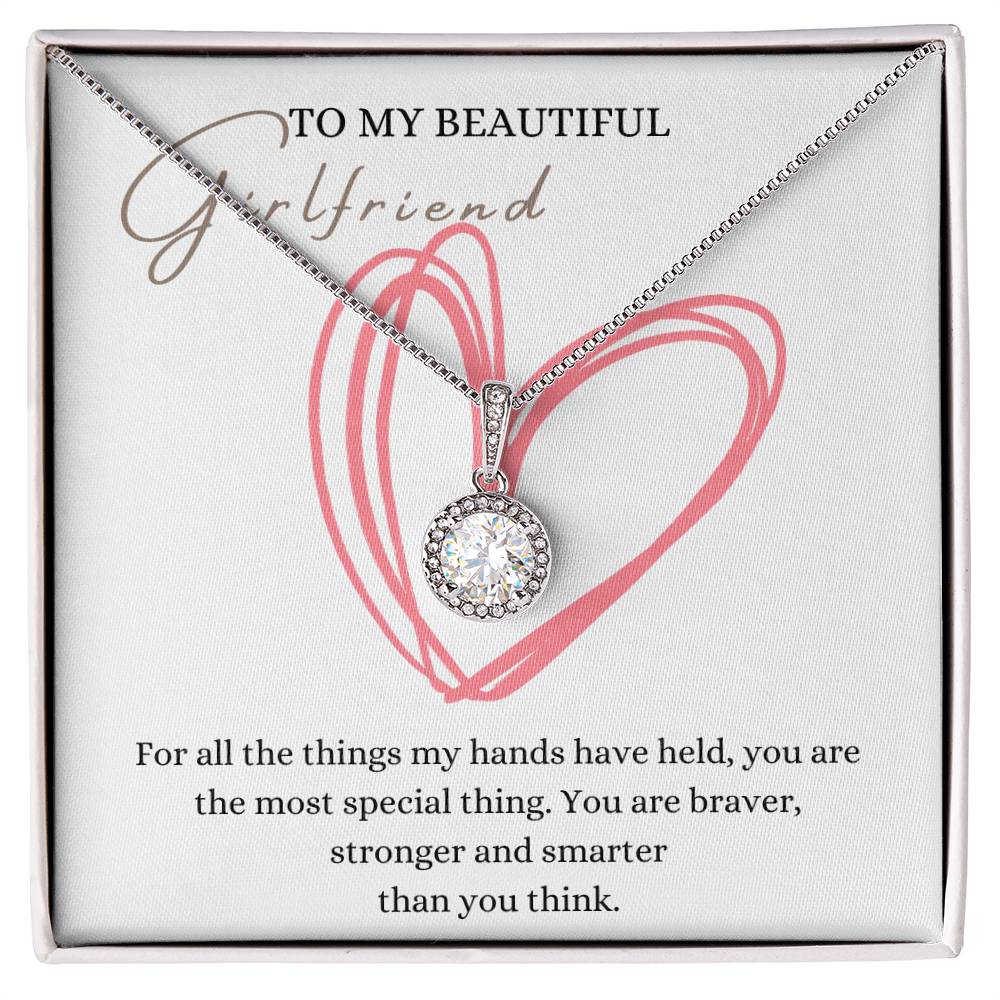 A necklace gift with a big cubic zirconia crystal pendant and a white gold finish, with a message card to my beautiful girlfriend, in a Jewelry box.