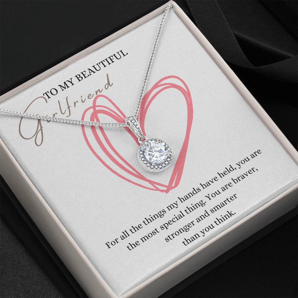 A necklace gift with a big cubic zirconia crystal pendant and a white gold finish, with a message card to my beautiful girlfriend, in a Jewelry box.