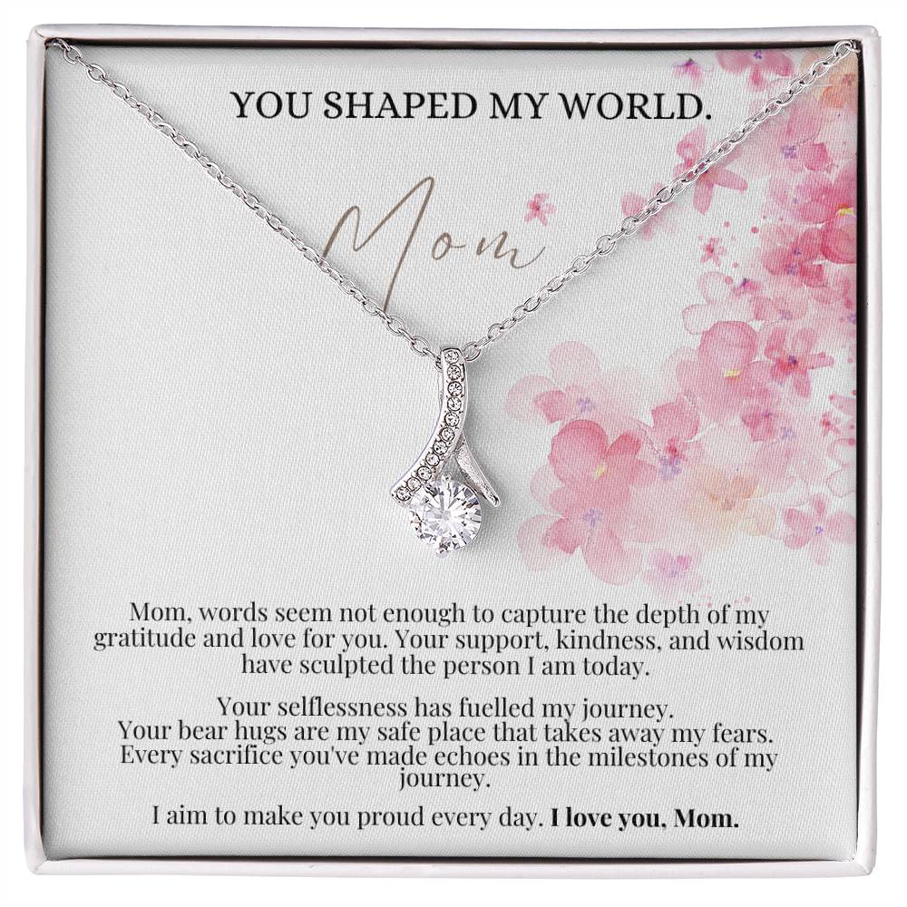 A necklace gift with ribbon shaped pendant with cubic zirconia crystals and white gold finish, with a Mother’s Day message card in a Jewelry box.